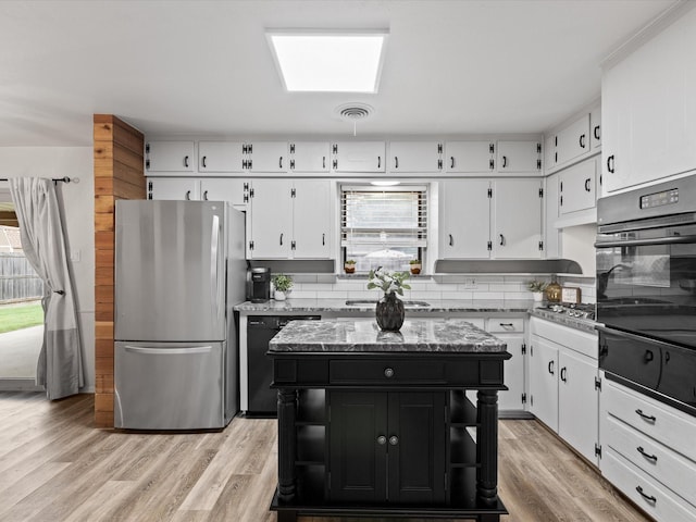 110 N Willow St, Mansfield, TX 76063 - kitchen featuring black appliances, white cabinets, and plenty of natural light