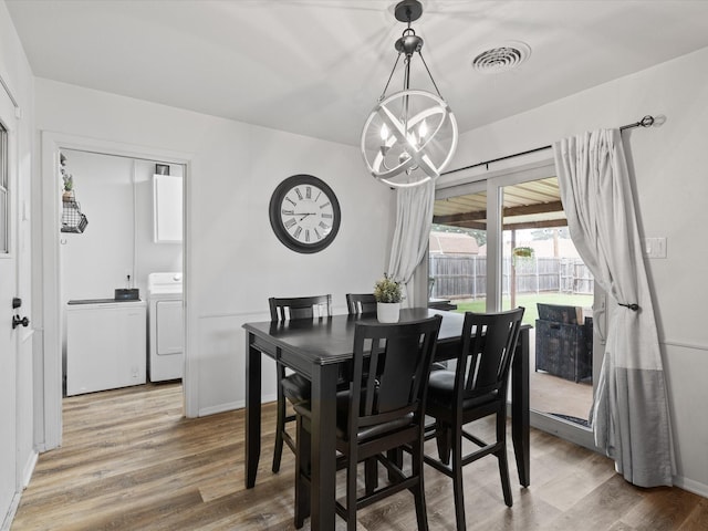 110 N Willow St, Mansfield, TX 76063 - dining room featuring a chandelier, wood finished floors, baseboards, and independent washer and dryer