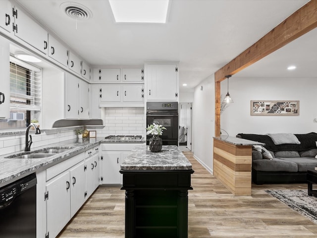 110 N Willow St, Mansfield, TX 76063 - kitchen with black appliances, a sink, open floor plan, decorative backsplash, and white cabinets