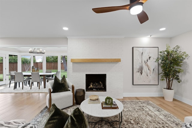 5009 Stacey Ave, Fort Worth, TX 76132 - living area with a chandelier, wood finished floors, baseboards, a brick fireplace, and ceiling fan