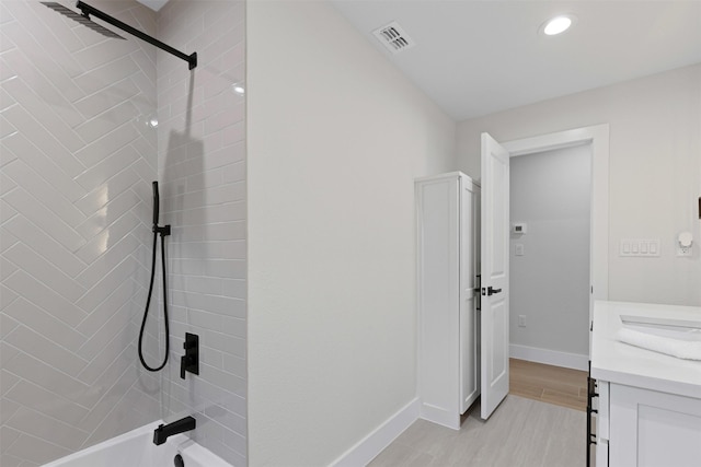 5009 Stacey Ave, Fort Worth, TX 76132 - full bathroom featuring vanity, baseboards, bathing tub / shower combination, recessed lighting, and wood finished floors