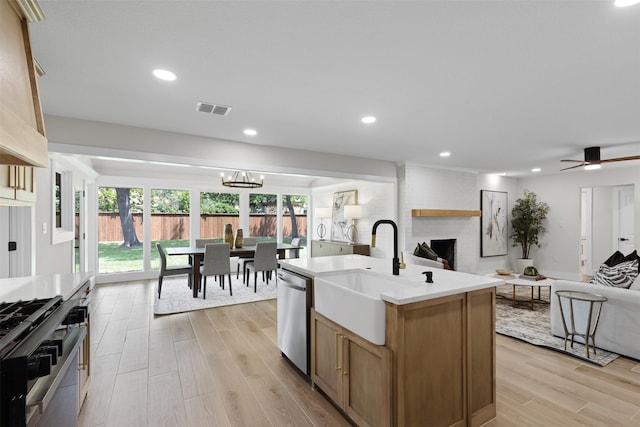 5009 Stacey Ave, Fort Worth, TX 76132 - kitchen with appliances with stainless steel finishes, open floor plan, a sink, light countertops, and light wood-style floors