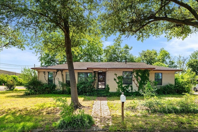 5401 Roberts St, Greenville, TX 75402 - ranch-style house featuring a front lawn and brick siding