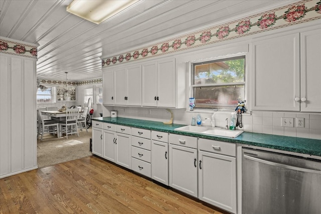 5401 Roberts St, Greenville, TX 75402 - kitchen with stainless steel dishwasher, a sink, white cabinets, ornamental molding, and dark countertops