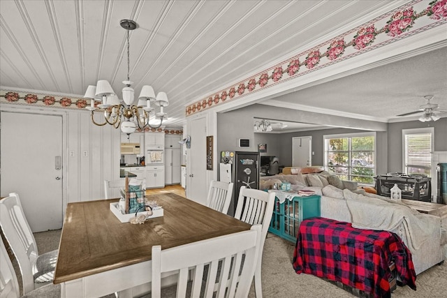 5401 Roberts St, Greenville, TX 75402 - dining area with a chandelier, crown molding, ceiling fan, and light carpet
