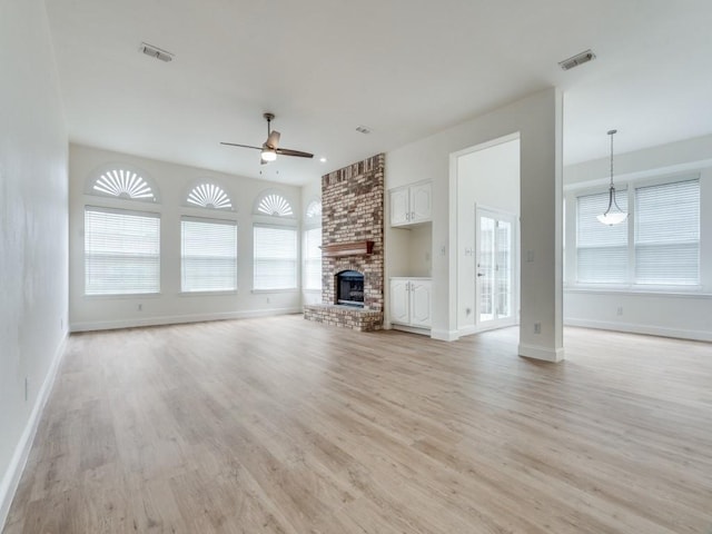 1428 Charlotte Way, Carrollton, TX 75007 - unfurnished living room featuring ceiling fan, light wood finished floors, and plenty of natural light