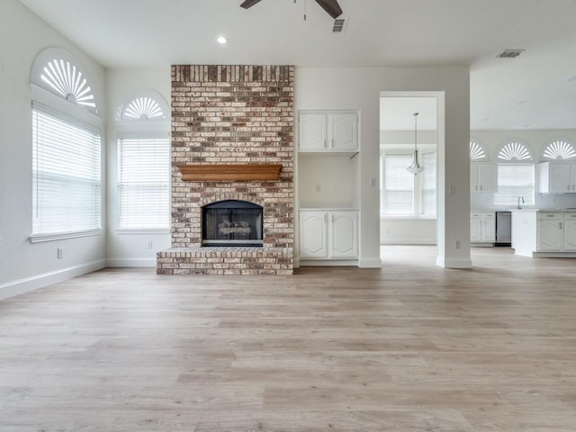 1428 Charlotte Way, Carrollton, TX 75007 - unfurnished living room with a ceiling fan, a sink, light wood finished floors, a fireplace, and recessed lighting