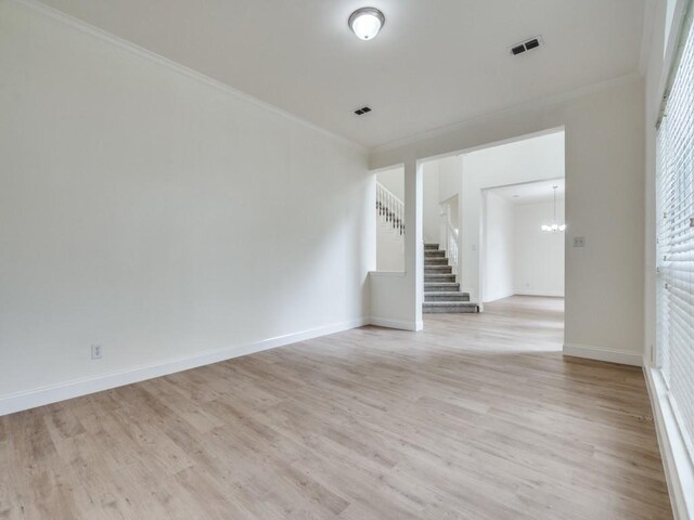 1428 Charlotte Way, Carrollton, TX 75007 - spare room with stairway, light wood finished floors, a chandelier, ornamental molding, and baseboards