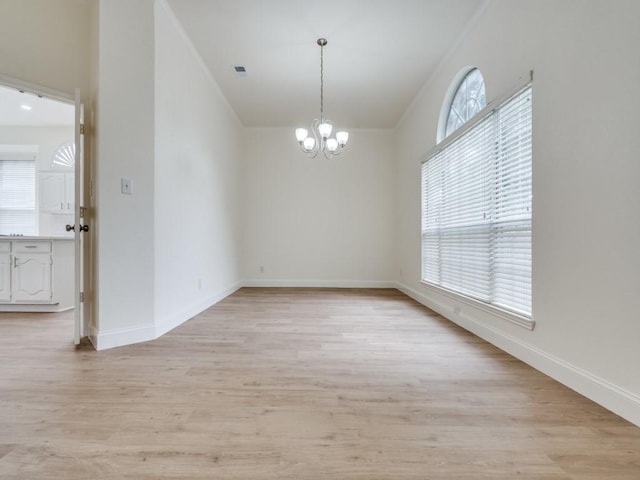 1428 Charlotte Way, Carrollton, TX 75007 - unfurnished room with a chandelier, light wood finished floors, and baseboards