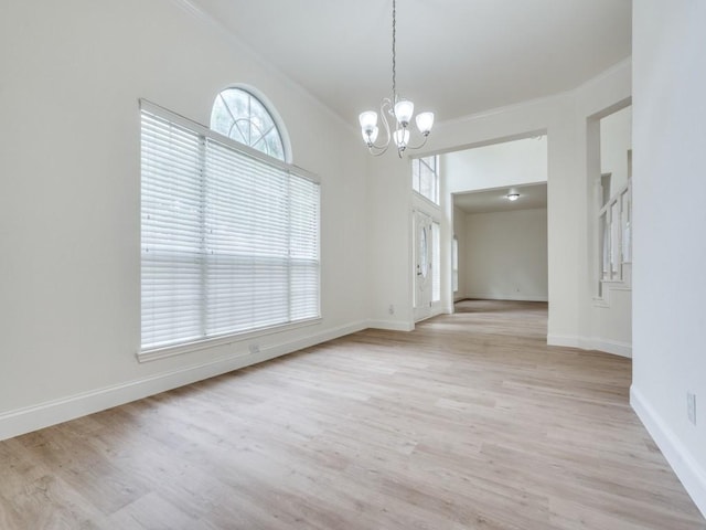 1428 Charlotte Way, Carrollton, TX 75007 - unfurnished room featuring a chandelier, light wood-style flooring, baseboards, and ornamental molding