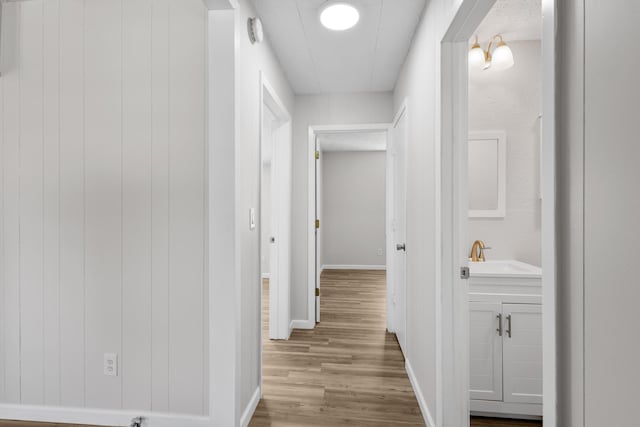 903 1st St, Bridgeport, TX 76426 - corridor with a sink, wood finished floors, and baseboards