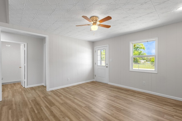 903 1st St, Bridgeport, TX 76426 - empty room with light wood-type flooring, baseboards, ceiling fan, and an ornate ceiling