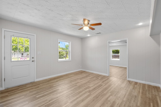 903 1st St, Bridgeport, TX 76426 - unfurnished living room featuring healthy amount of natural light, a ceiling fan, light wood finished floors, and baseboards