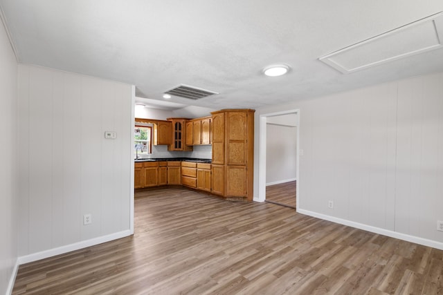 903 1st St, Bridgeport, TX 76426 - kitchen featuring wood finished floors, dark countertops, glass insert cabinets, and baseboards