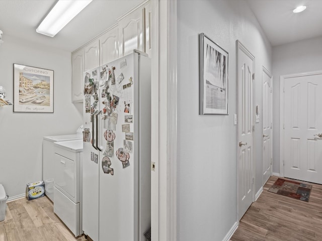 3709 Cliff View Loop, Weatherford, TX 76087 - laundry area featuring separate washer and dryer, light wood-type flooring, baseboards, and cabinet space