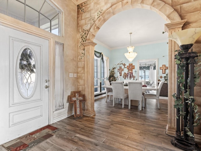 3709 Cliff View Loop, Weatherford, TX 76087 - foyer entrance with plenty of natural light, arched walkways, a chandelier, wood finished floors, and ornamental molding