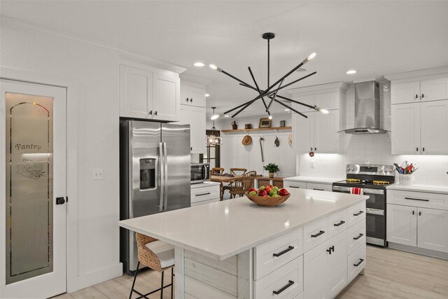4675 County Road 2216, Caddo Mills, TX 75135 - kitchen featuring wall chimney exhaust hood, stainless steel appliances, a chandelier, tasteful backsplash, and light countertops