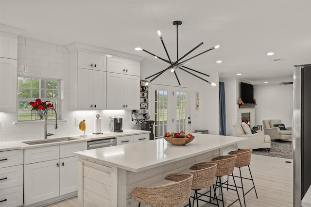 4675 County Road 2216, Caddo Mills, TX 75135 - kitchen with a sink, healthy amount of natural light, a kitchen island, decorative backsplash, and recessed lighting