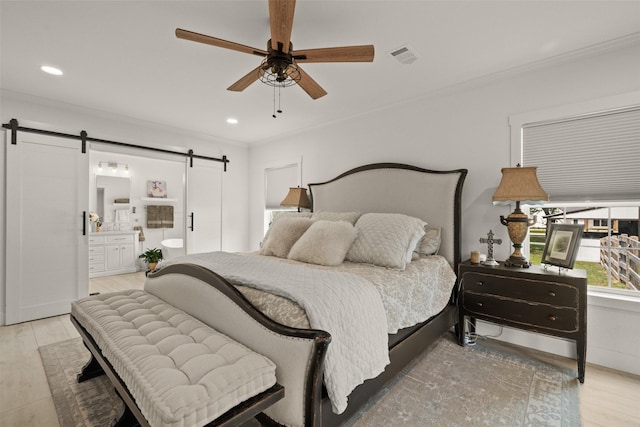 4675 County Road 2216, Caddo Mills, TX 75135 - bedroom featuring a barn door, wood finished floors, ornamental molding, connected bathroom, and recessed lighting