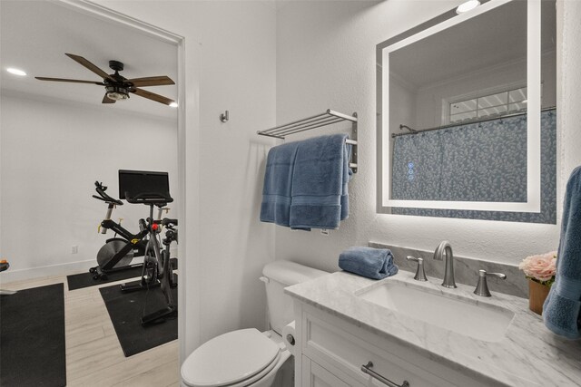 4675 County Road 2216, Caddo Mills, TX 75135 - full bath featuring a ceiling fan, vanity, wood finished floors, toilet, and a shower with curtain