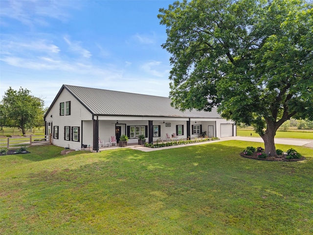 4675 County Road 2216, Caddo Mills, TX 75135 - view of front facade with a ceiling fan, a front yard, driveway, a garage, and metal roof