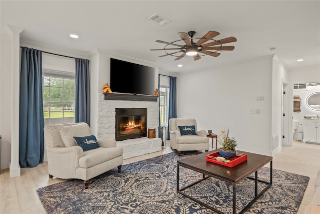 4675 County Road 2216, Caddo Mills, TX 75135 - living room with ornamental molding, a fireplace, ceiling fan, recessed lighting, and light wood-style flooring