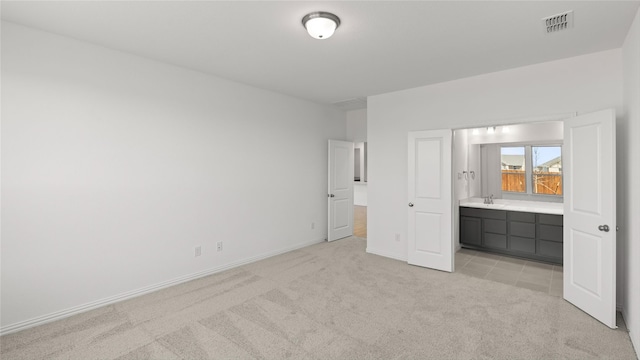 7545 Wild Mint Trl, Midlothian, TX 76084 - unfurnished bedroom featuring light carpet, baseboards, ensuite bathroom, and a sink