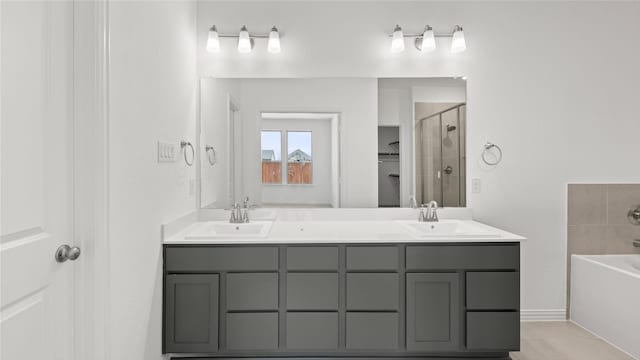 7545 Wild Mint Trl, Midlothian, TX 76084 - bathroom with a garden tub, a stall shower, double vanity, and baseboards