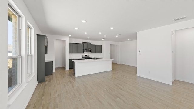 7545 Wild Mint Trl, Midlothian, TX 76084 - kitchen with stainless steel microwave, range with gas cooktop, plenty of natural light, recessed lighting, and light countertops