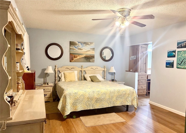 508 Fox Trl, Greenville, TX 75402 - bedroom with wood finished floors, a textured ceiling, ceiling fan, and baseboards