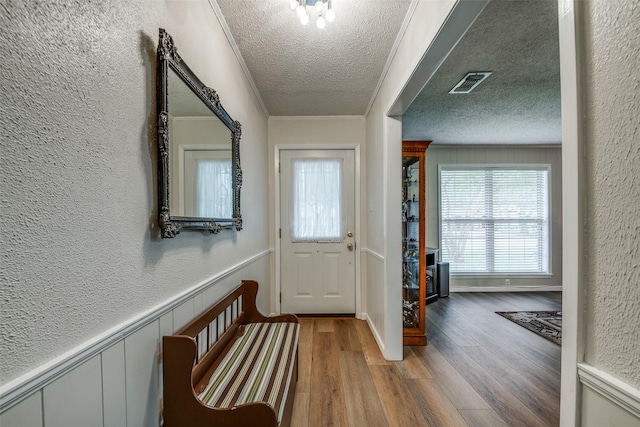 508 Fox Trl, Greenville, TX 75402 - entrance foyer featuring a textured ceiling, wood finished floors, a textured wall, and wainscoting