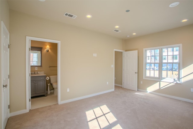 2916 Sale St, Dallas, TX 75219 - unfurnished bedroom with light carpet, recessed lighting, baseboards, and ensuite bathroom