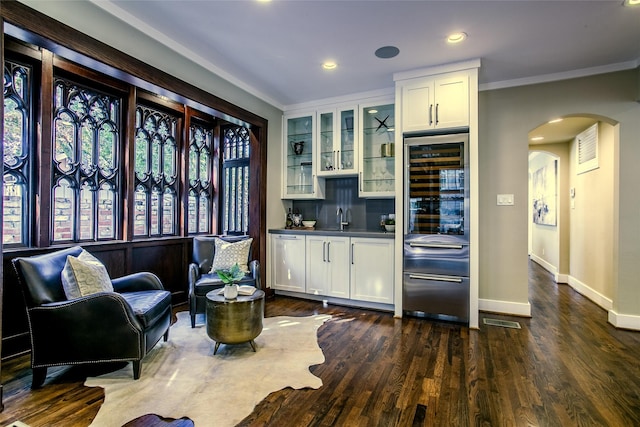 2916 Sale St, Dallas, TX 75219 - kitchen with arched walkways, baseboards, glass insert cabinets, white cabinets, and crown molding