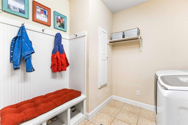 118 Royal Springs Ln, Crawford, TX 76638 - mudroom with washer and clothes dryer, light tile patterned floors, and baseboards