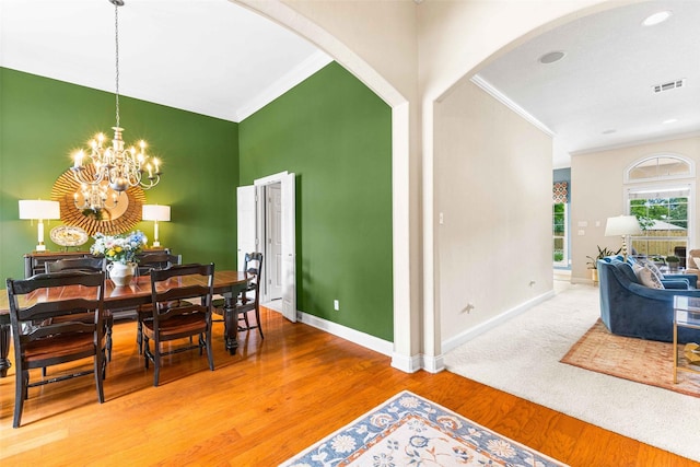 118 Royal Springs Ln, Crawford, TX 76638 - dining area with crown molding, arched walkways, baseboards, a chandelier, and wood finished floors