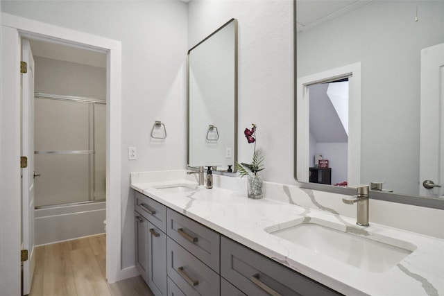 1302 Kelly Green Ct, Keller, TX 76248 - bathroom with double vanity, wood finished floors, and combined bath / shower with glass door