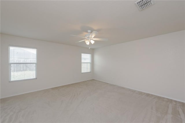 2913 Paddock Way, Denton, TX 76210 - spare room with light colored carpet, a ceiling fan, and baseboards