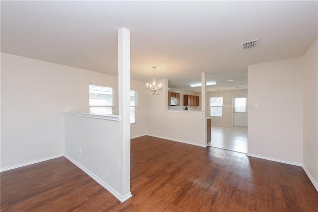 2913 Paddock Way, Denton, TX 76210 - empty room featuring a chandelier, baseboards, and wood finished floors