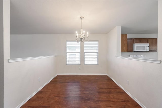 2913 Paddock Way, Denton, TX 76210 - unfurnished dining area with a chandelier, wood finished floors, and baseboards