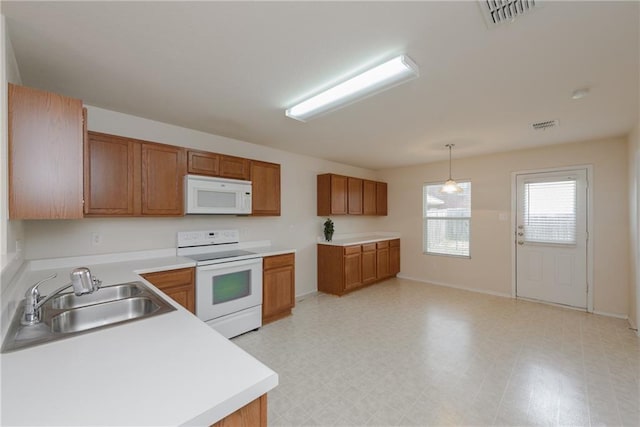 2913 Paddock Way, Denton, TX 76210 - kitchen with white appliances, a sink, brown cabinets, and light countertops
