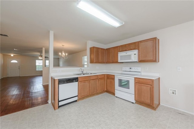 2913 Paddock Way, Denton, TX 76210 - kitchen with white appliances, a sink, light countertops, and a chandelier