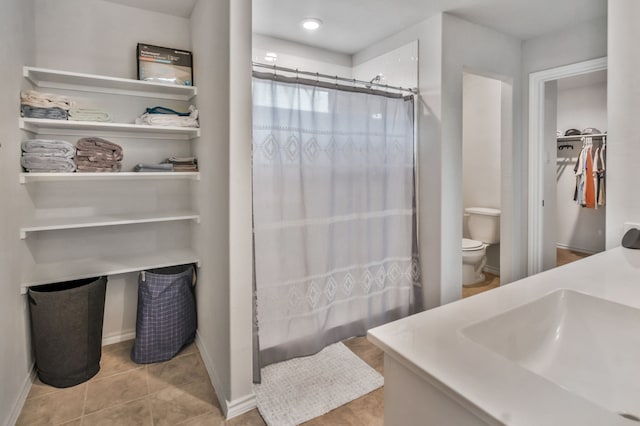 16637 Friesland Ln, Justin, TX 76247 - full bathroom with toilet, tile patterned flooring, a spacious closet, shower / bath combo with shower curtain, and vanity