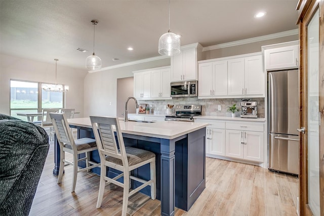 4017 Crick Ct, Weatherford, TX 76087 - kitchen with appliances with stainless steel finishes, a sink, backsplash, light wood-style flooring, and white cabinetry