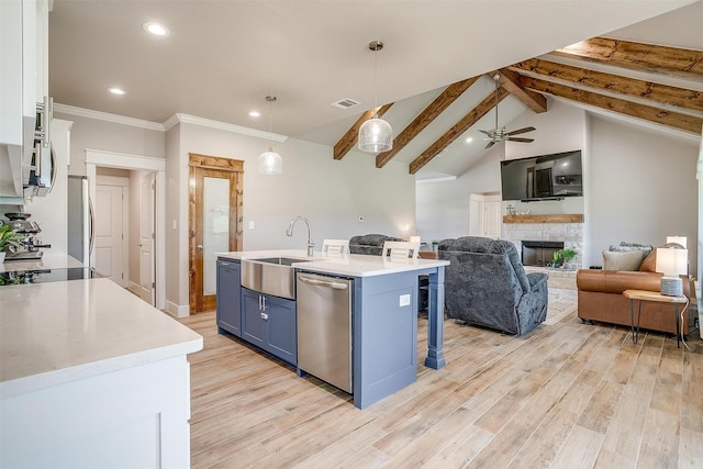 4017 Crick Ct, Weatherford, TX 76087 - kitchen with appliances with stainless steel finishes, a sink, blue cabinets, light countertops, and recessed lighting
