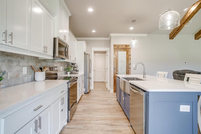4017 Crick Ct, Weatherford, TX 76087 - kitchen with appliances with stainless steel finishes, a sink, light wood-style flooring, white cabinets, and a kitchen island with sink