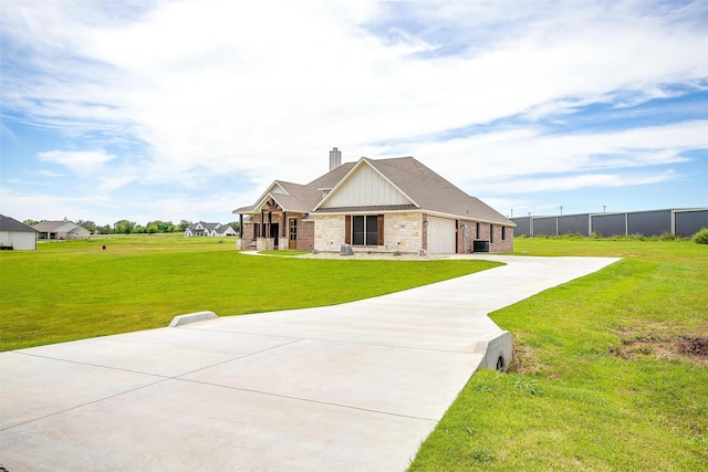 4017 Crick Ct, Weatherford, TX 76087 - view of front of house featuring a garage, a chimney, driveway, board and batten siding, and central AC unit