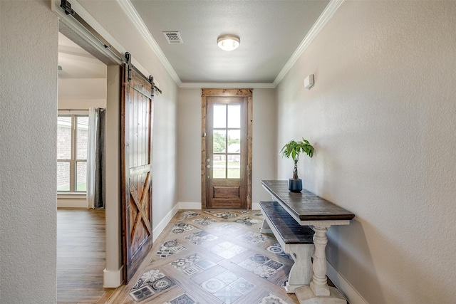 4017 Crick Ct, Weatherford, TX 76087 - entryway with a barn door, crown molding, baseboards, and a textured wall