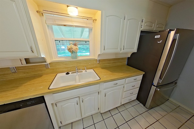 1602 England Rd, Arlington, TX 76013 - kitchen with stainless steel appliances, a sink, light countertops, and white cabinetry