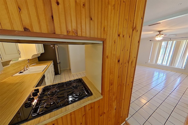 1602 England Rd, Arlington, TX 76013 - kitchen featuring black gas cooktop, light tile patterned flooring, light countertops, a sink, and ceiling fan
