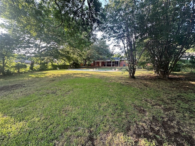 1602 England Rd, Arlington, TX 76013 - view of green lawn featuring a swimming pool and a sunroom
